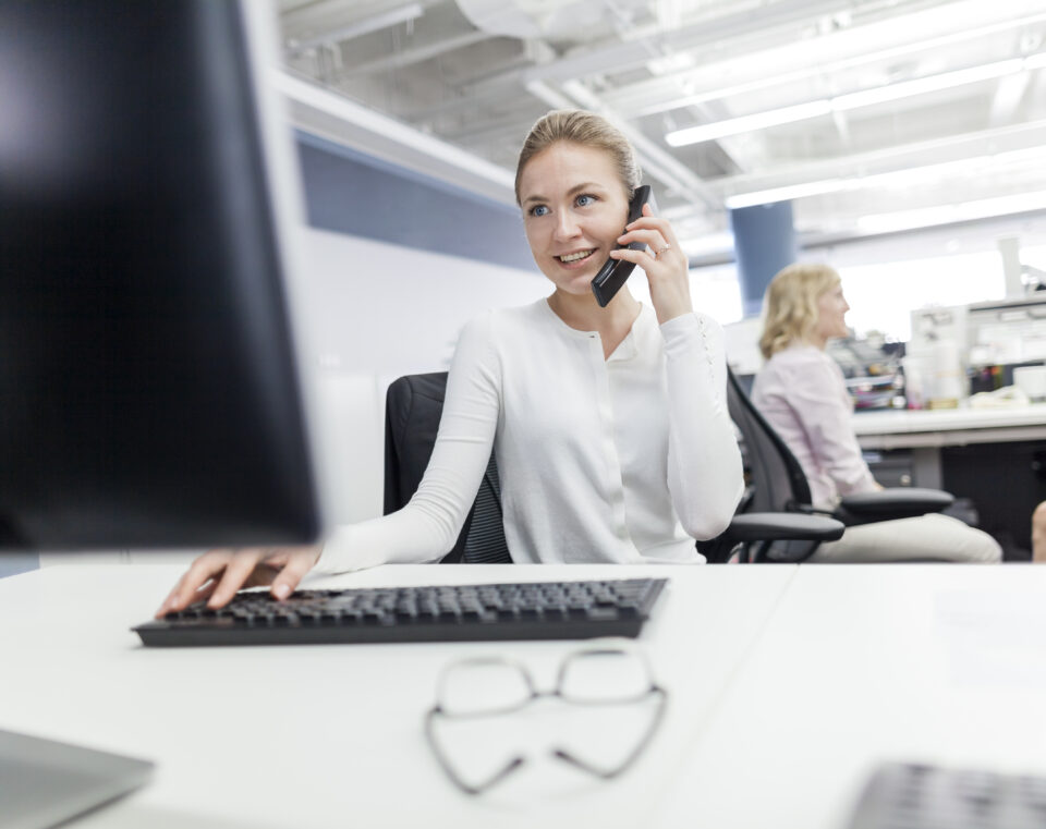 Woman using phone in office